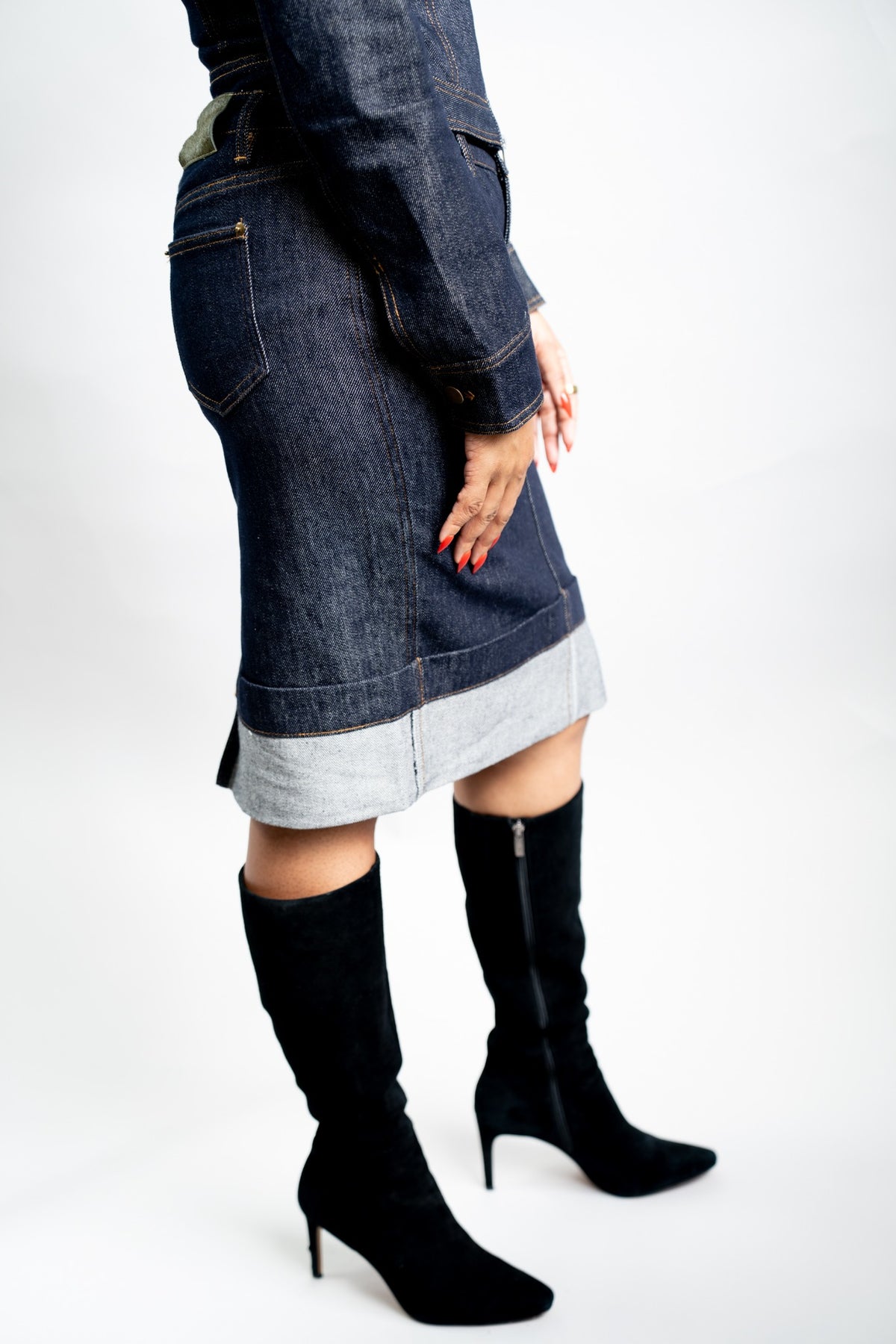 Woman modeling the indigo denim pencil skirt with the matching fitted jacket