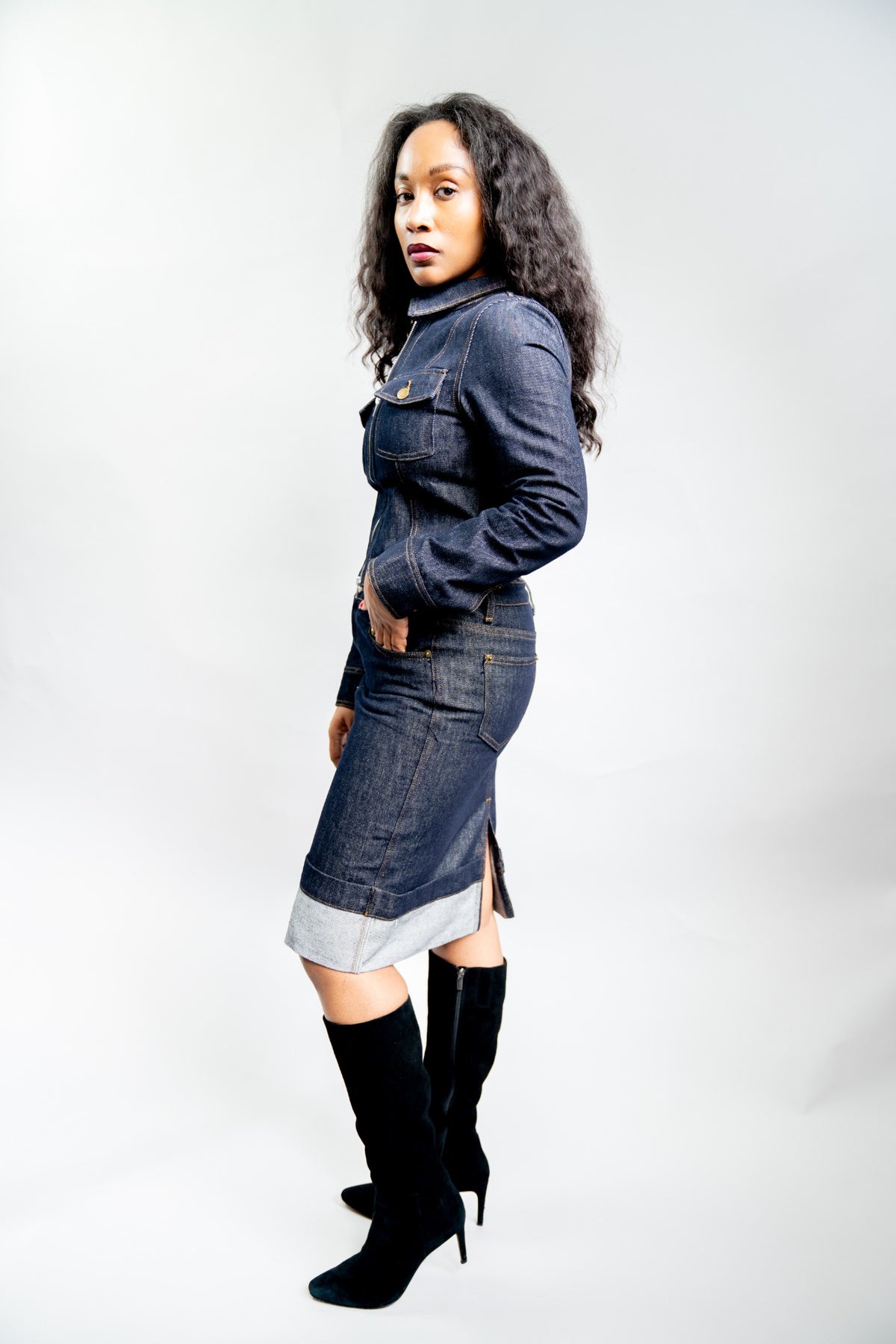 Three-quarter view of a woman wearing the indigo denim pencil skirt and jacket