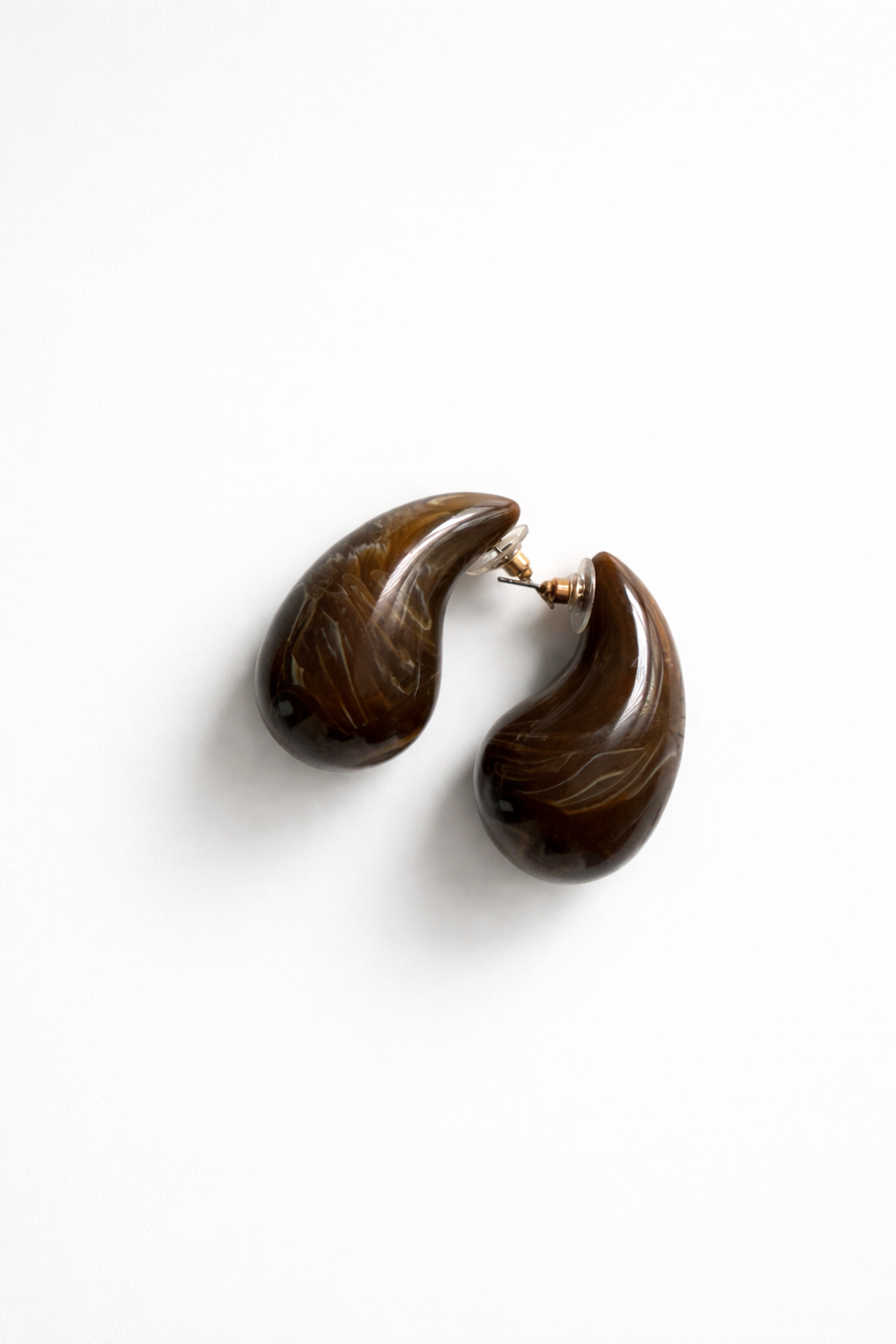 Pair of brown teardrop-shaped earrings on a white background
