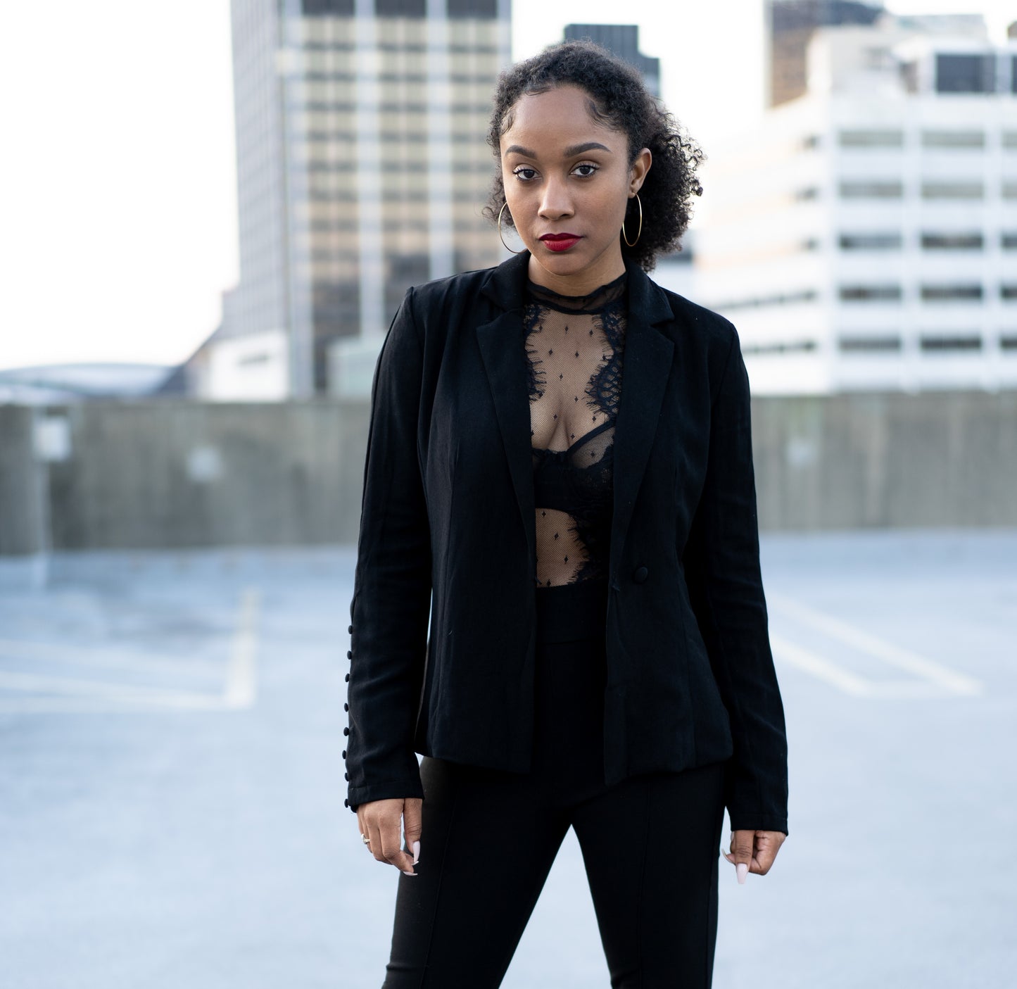 model wearing Going-Out black Blazer with city in the background